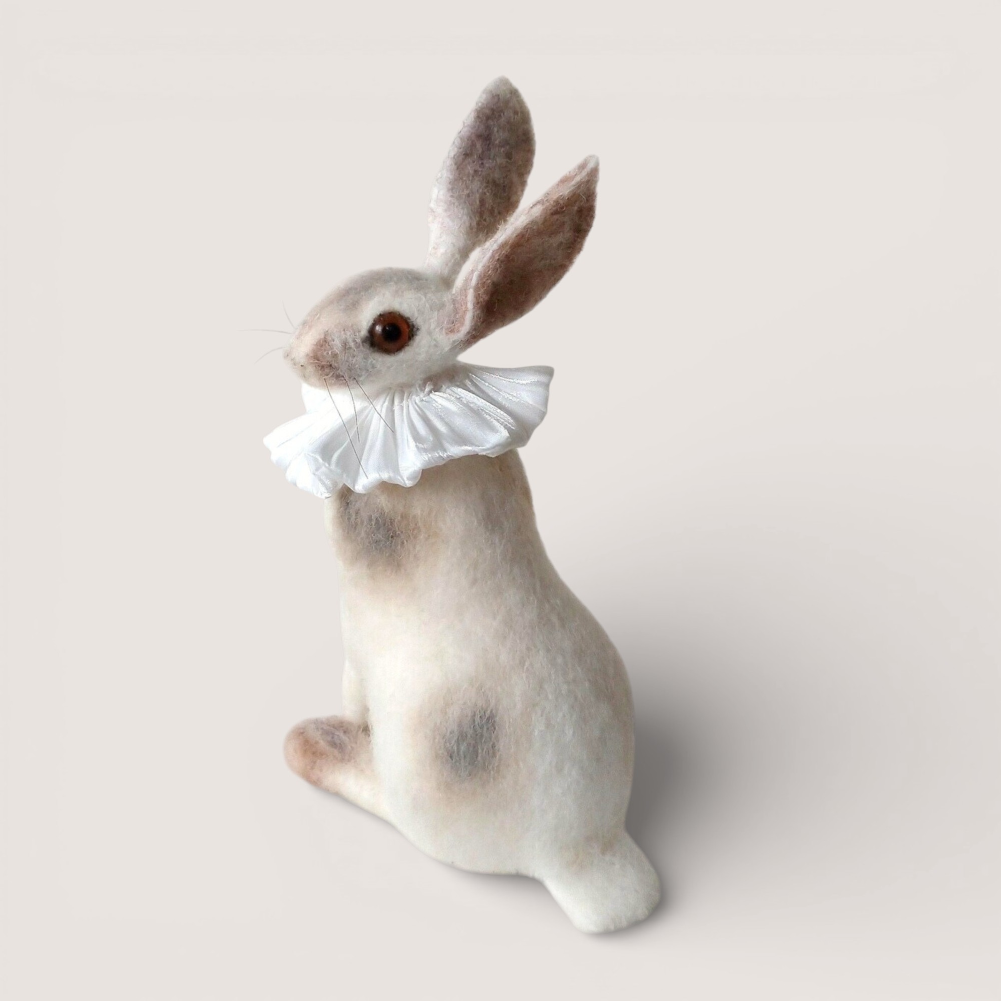 Needle-felted hare sculpture wearing a white winter ruffle by Grey Wren Studio.